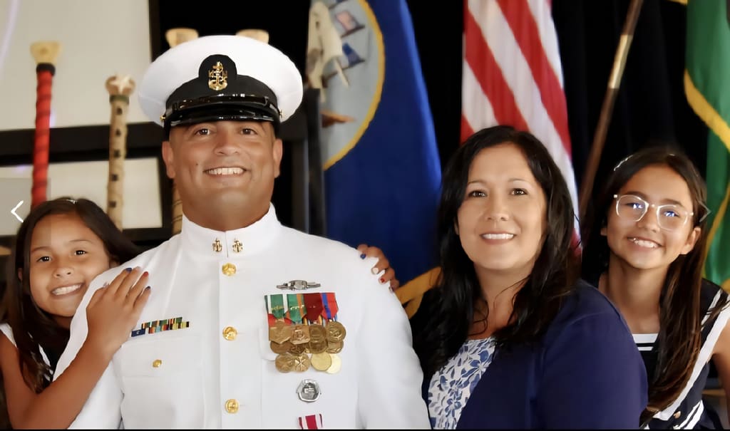 Adam Musgrove with family at a military ceremony.
